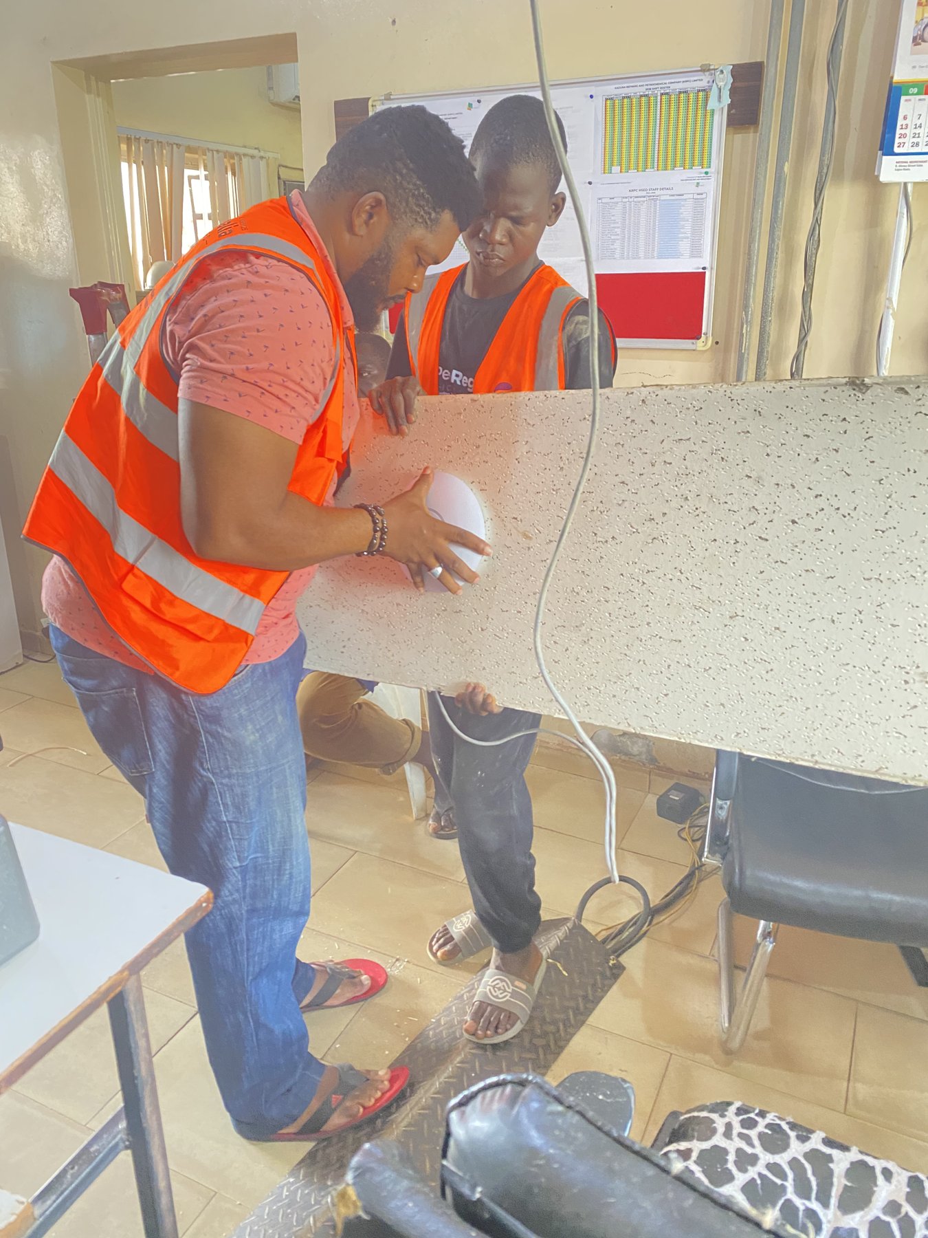 The installation team preparing the access point and cabling.